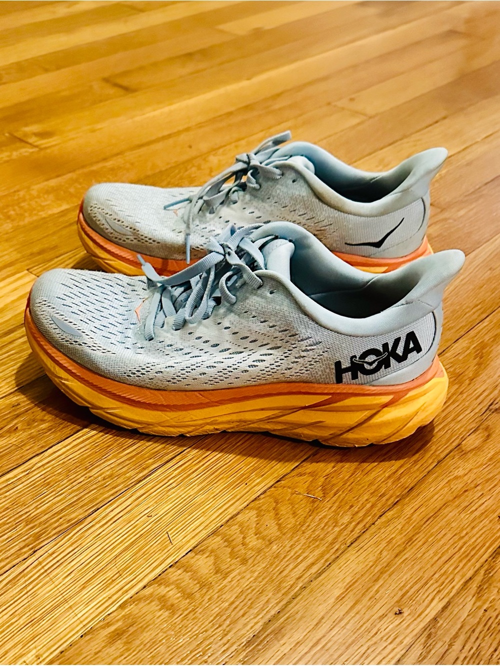 Hoka Women’s Light Blue Running Shoe with Orange and Pink Midsole